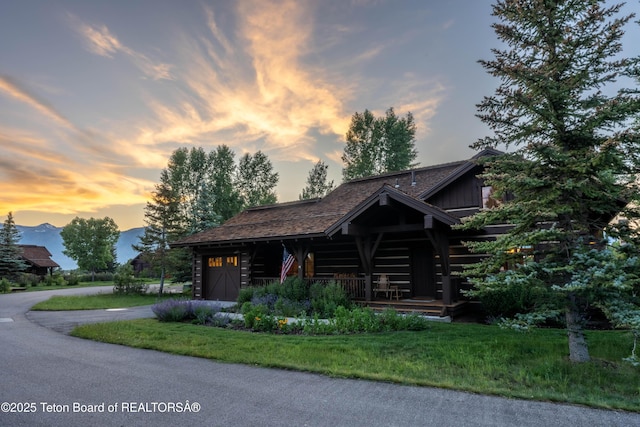 5862 N Coneflower Dr Unit 17, Jackson, WY 83001 - log home with log exterior, driveway, a garage, covered porch, and board and batten siding