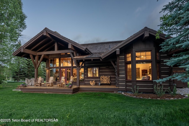 5862 N Coneflower Dr Unit 17, Jackson, WY 83001 - rear view of house featuring a lawn, a deck, and log siding