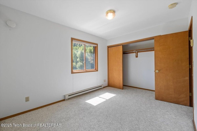 816 Powderhorn Ln Unit 816D, Jackson, WY 83001 - unfurnished bedroom featuring a baseboard radiator, carpet flooring, and a closet