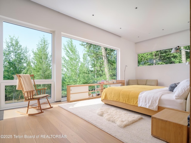 7970 N Granite Ridge Rd, Teton Village, WY 83025 - bedroom with wood finished floors and view of wooded area