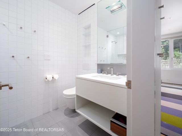 7970 N Granite Ridge Rd, Teton Village, WY 83025 - bathroom featuring vanity, tile patterned floors, tile walls, and tiled shower