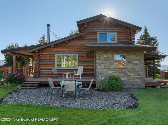 5100 Country Club Dr, Victor, ID 83455 - back of house featuring a deck, log exterior, stone siding, and a lawn
