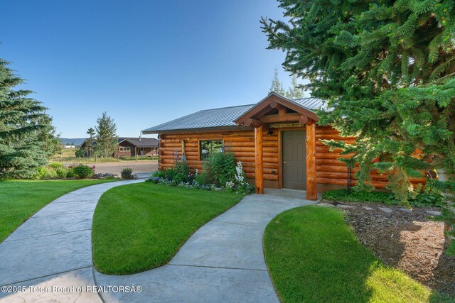 5100 Country Club Dr, Victor, ID 83455 - log-style house with log siding, a front lawn, and a metal roof