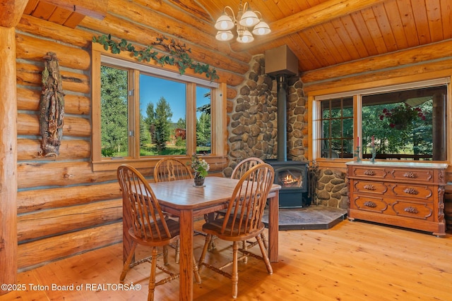 5100 Country Club Dr, Victor, ID 83455 - dining room with a wood stove, rustic walls, a wood ceiling with exposed beams, hardwood / wood-style flooring, and a chandelier