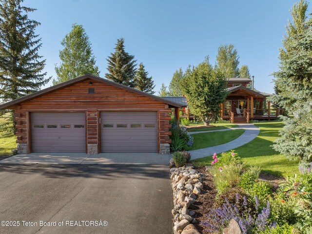 5100 Country Club Dr, Victor, ID 83455 - cabin with log siding, a front yard, a metal roof, and an outbuilding