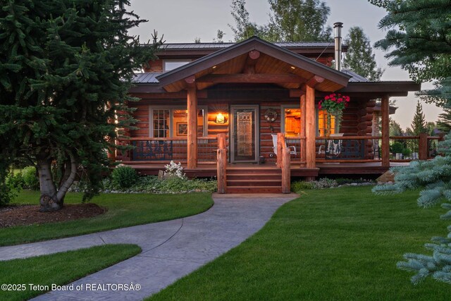 5100 Country Club Dr, Victor, ID 83455 - log home with log siding, a metal roof, and a front yard