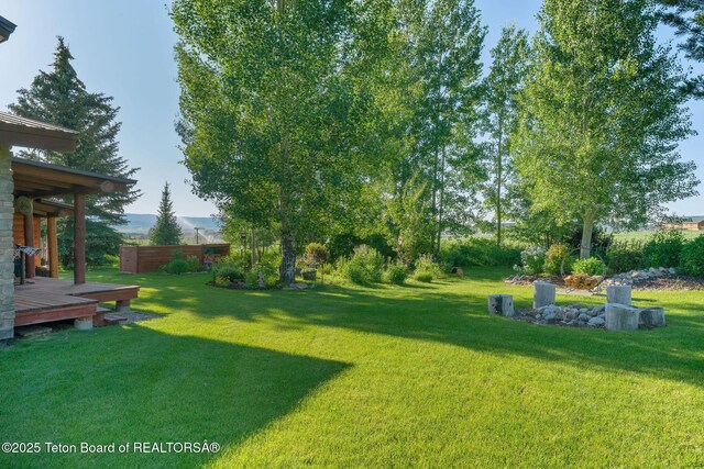 5100 Country Club Dr, Victor, ID 83455 - view of grassy yard with a deck