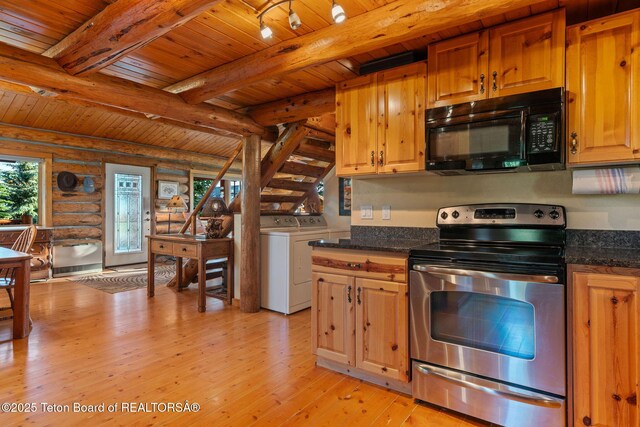 5100 Country Club Dr, Victor, ID 83455 - kitchen with black microwave, stainless steel electric stove, independent washer and dryer, rustic walls, and a wooden ceiling with exposed beams