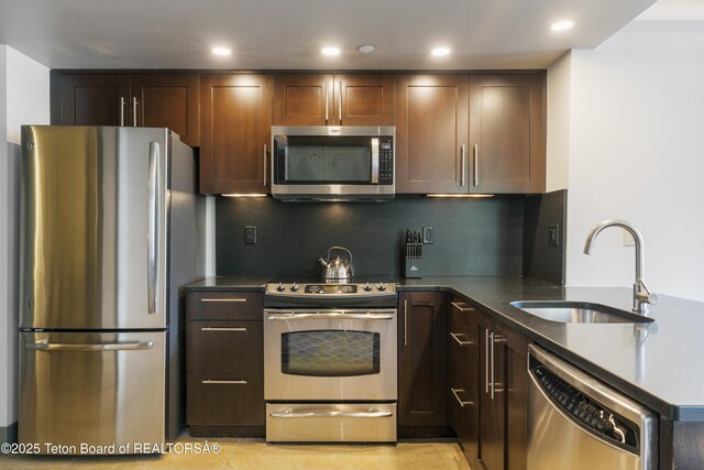 3325 W Village Dr Unit 359/361, Teton Village, WY 83025 - kitchen featuring appliances with stainless steel finishes, a peninsula, decorative backsplash, dark brown cabinetry, and recessed lighting