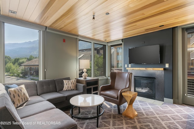 3325 W Village Dr Unit 359/361, Teton Village, WY 83025 - living room featuring wood ceiling, a mountain view, a glass covered fireplace, and plenty of natural light