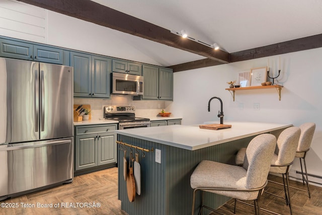 550 E Golf Creek Ln Unit 41, Jackson, WY 83001 - kitchen with stainless steel appliances, a kitchen breakfast bar, a peninsula, open shelves, and light countertops