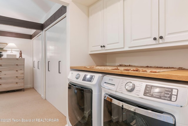 550 E Golf Creek Ln Unit 41, Jackson, WY 83001 - laundry room featuring cabinet space, washing machine and clothes dryer, and light carpet
