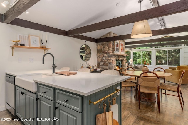 550 E Golf Creek Ln Unit 41, Jackson, WY 83001 - kitchen with dishwasher, open floor plan, a fireplace, light countertops, and gray cabinets