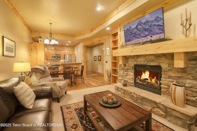 122 Hastings Dr Unit 207, Victor, ID 83455 - living room featuring a chandelier, a stone fireplace, recessed lighting, light wood-type flooring, and ornamental molding