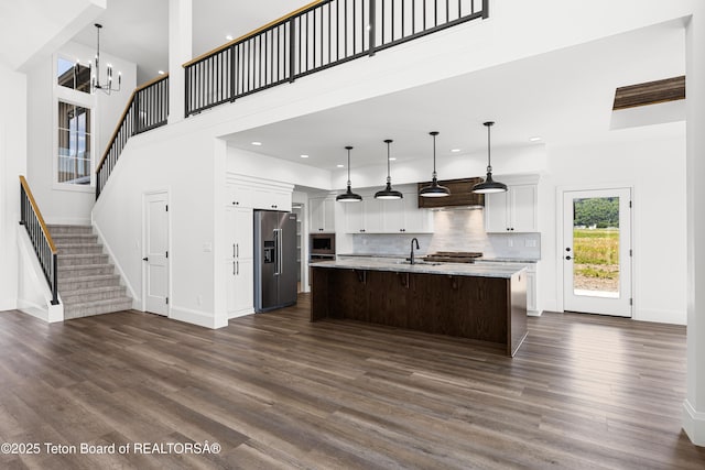 555 Silver Fox Ln, Victor, ID 83455 - kitchen featuring stainless steel appliances, custom range hood, dark wood-style flooring, a high ceiling, and recessed lighting