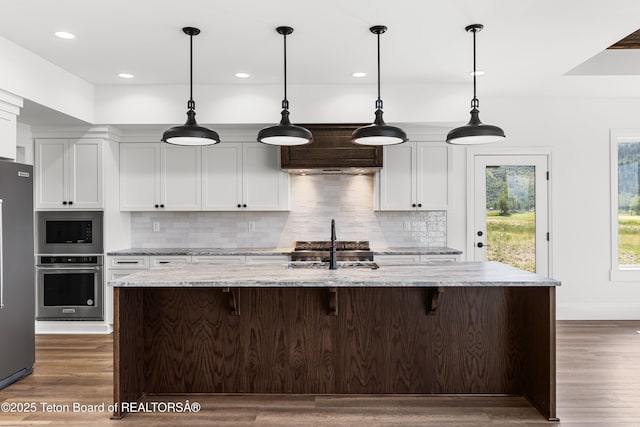 555 Silver Fox Ln, Victor, ID 83455 - kitchen featuring appliances with stainless steel finishes, tasteful backsplash, white cabinetry, and recessed lighting
