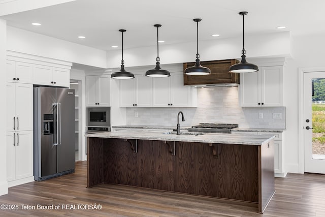 555 Silver Fox Ln, Victor, ID 83455 - kitchen with stainless steel appliances, custom range hood, dark wood-style flooring, tasteful backsplash, and recessed lighting