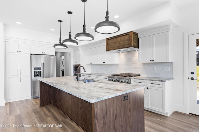 555 Silver Fox Ln, Victor, ID 83455 - kitchen featuring appliances with stainless steel finishes, light wood-style floors, tasteful backsplash, recessed lighting, and white cabinets