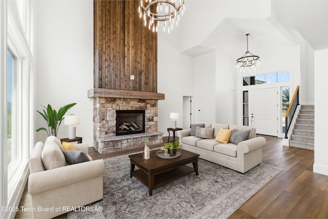 555 Silver Fox Ln, Victor, ID 83455 - living area featuring a chandelier, a high ceiling, wood finished floors, stairs, and a fireplace