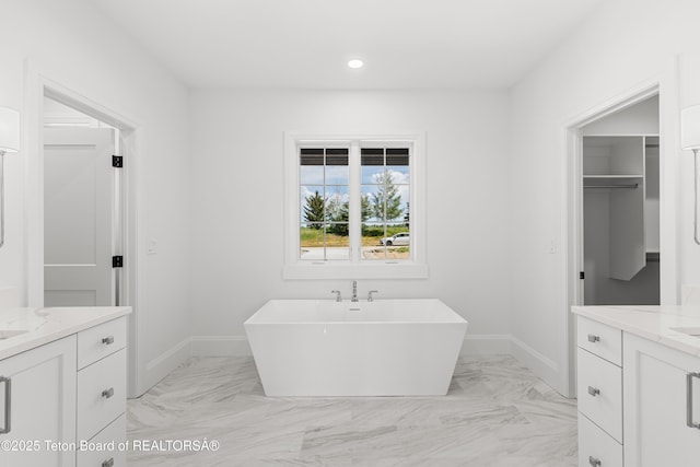555 Silver Fox Ln, Victor, ID 83455 - full bathroom with two vanities, a soaking tub, marble look tile flooring, and recessed lighting