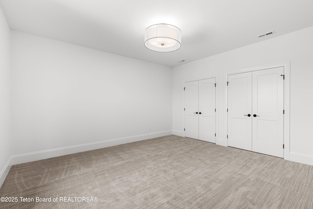555 Silver Fox Ln, Victor, ID 83455 - unfurnished bedroom with multiple closets and carpet flooring