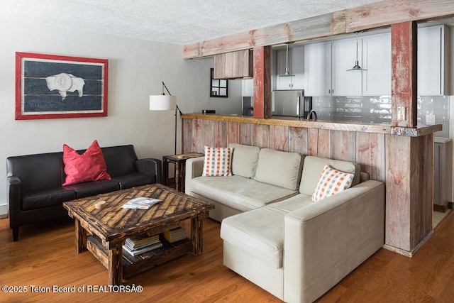 3885 S Lake Creek Dr Unit 1013, Wilson, WY 83014 - living area with wood finished floors and a textured ceiling