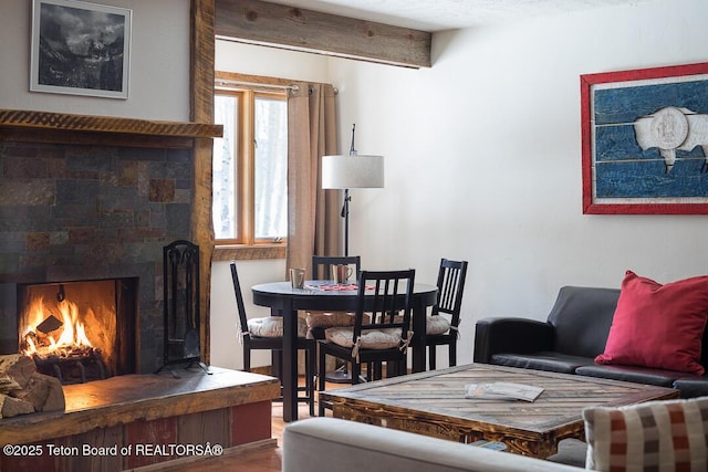 3885 S Lake Creek Dr Unit 1013, Wilson, WY 83014 - living area featuring a warm lit fireplace and wood finished floors