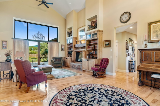 6289 Fox Meadows Dr, Victor, ID 83455 - living area with high vaulted ceiling, wood finished floors, ceiling fan, a fireplace with raised hearth, and recessed lighting