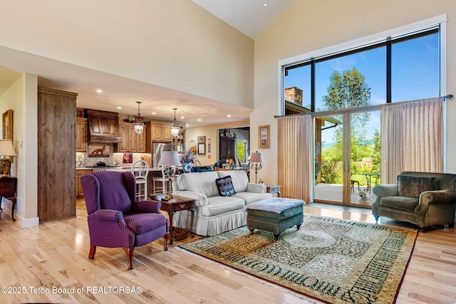 6289 Fox Meadows Dr, Victor, ID 83455 - living area featuring high vaulted ceiling, light wood-style flooring, plenty of natural light, and recessed lighting