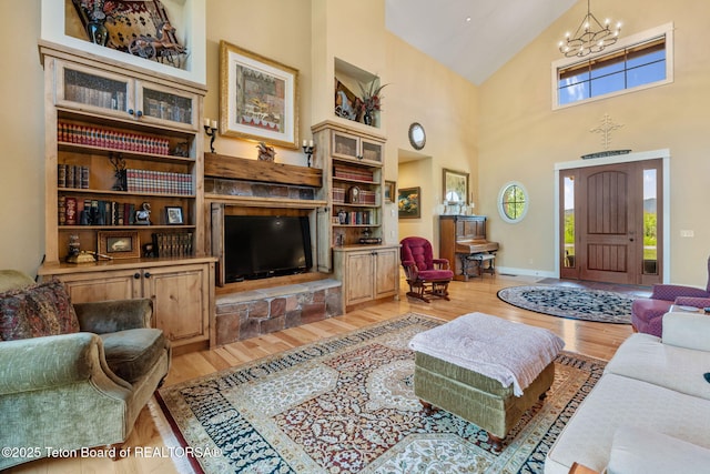 6289 Fox Meadows Dr, Victor, ID 83455 - living room with light wood finished floors, a chandelier, high vaulted ceiling, and healthy amount of natural light