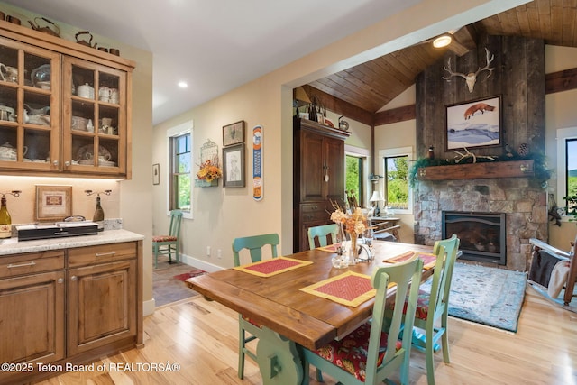 6289 Fox Meadows Dr, Victor, ID 83455 - dining space featuring light wood-style floors, vaulted ceiling, a stone fireplace, and recessed lighting