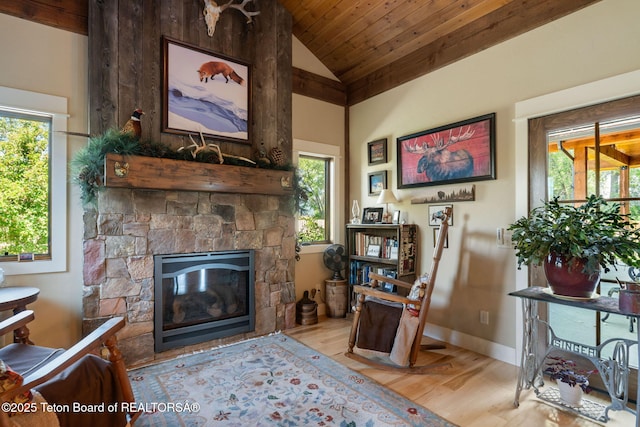 6289 Fox Meadows Dr, Victor, ID 83455 - living area with wood finished floors, vaulted ceiling, a stone fireplace, and wood ceiling