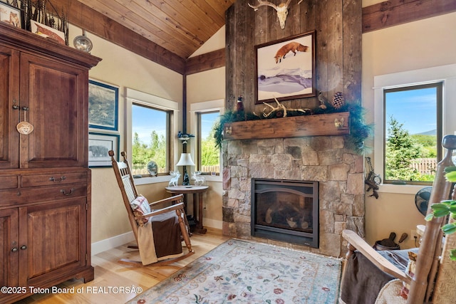 6289 Fox Meadows Dr, Victor, ID 83455 - living area featuring vaulted ceiling, light wood-style flooring, a stone fireplace, and wood ceiling