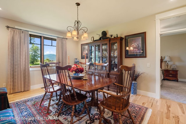 6289 Fox Meadows Dr, Victor, ID 83455 - dining space featuring a chandelier and wood finished floors
