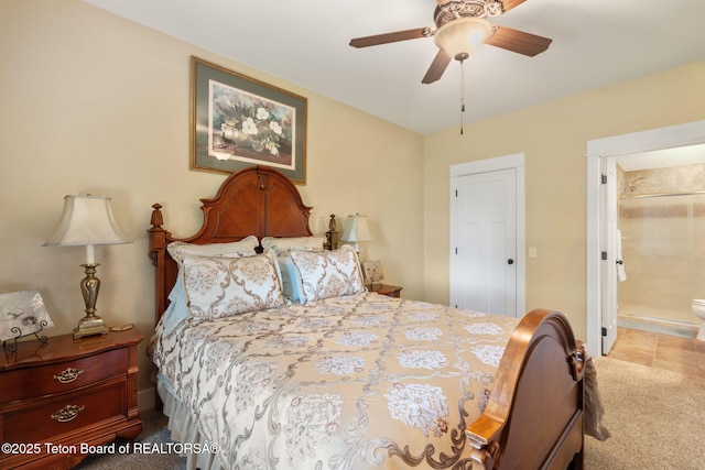 6289 Fox Meadows Dr, Victor, ID 83455 - carpeted bedroom with ensuite bathroom, ceiling fan, and tile patterned flooring