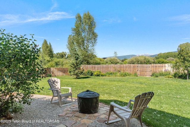 6289 Fox Meadows Dr, Victor, ID 83455 - fenced backyard featuring an outdoor fire pit