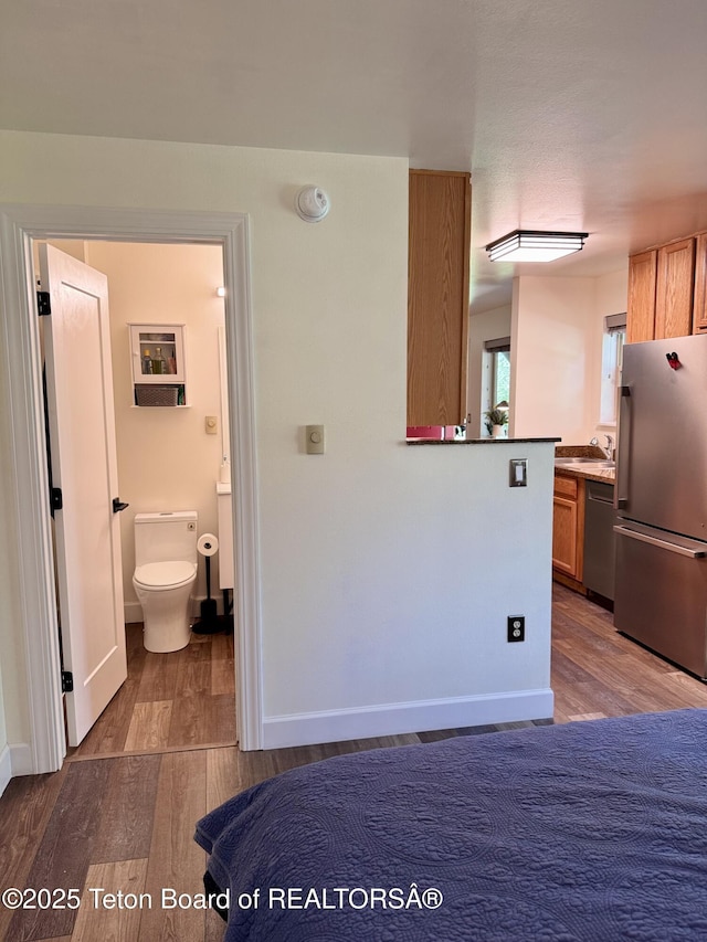 220 Homestead Rd Unit 203, Victor, ID 83455 - kitchen featuring stainless steel appliances, wood finished floors, and brown cabinets