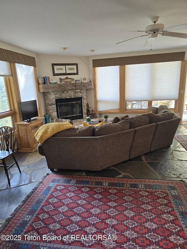 750 N Bar Y Rd, Jackson, WY 83001 - living area with plenty of natural light, a stone fireplace, and ceiling fan