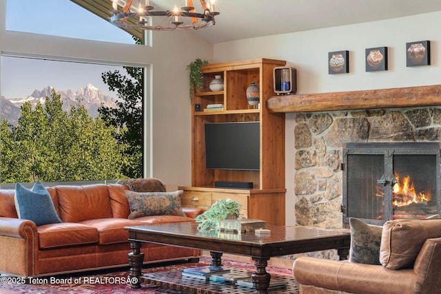 750 N Bar Y Rd, Jackson, WY 83001 - living area with a chandelier, a fireplace, a mountain view, and plenty of natural light