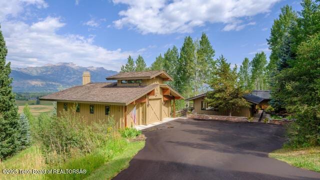 750 N Bar Y Rd, Jackson, WY 83001 - view of front of home with a chimney and a mountain view