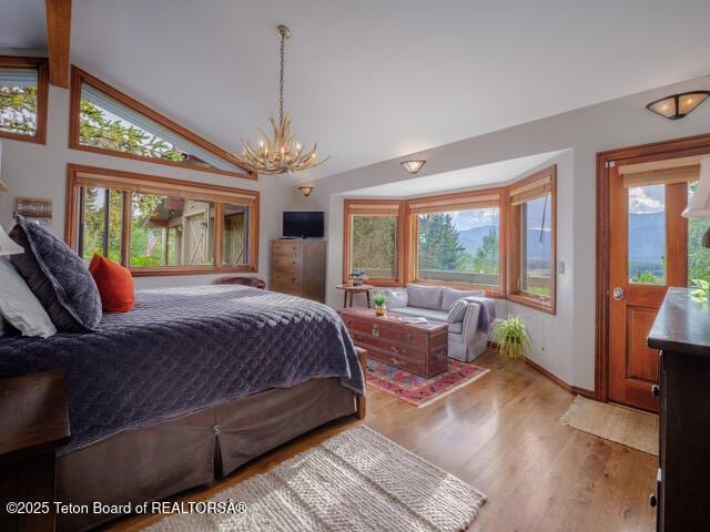 750 N Bar Y Rd, Jackson, WY 83001 - bedroom with a chandelier, wood finished floors, and high vaulted ceiling