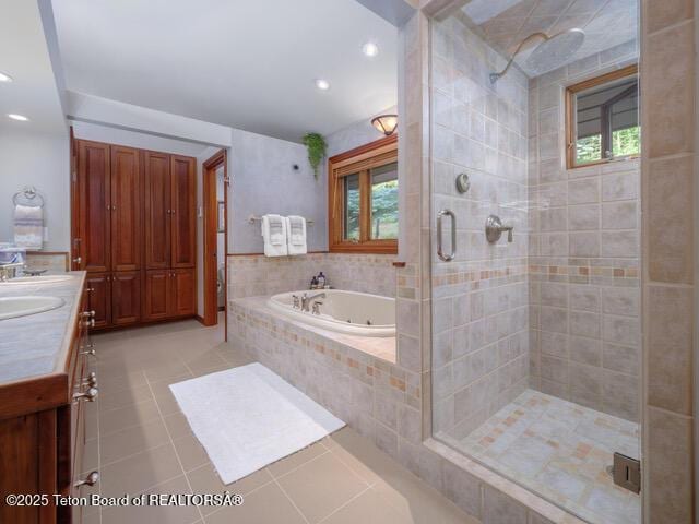750 N Bar Y Rd, Jackson, WY 83001 - full bath with tile patterned flooring, plenty of natural light, a jetted tub, a stall shower, and recessed lighting