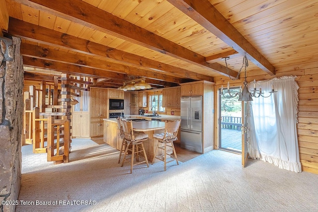 386 Dogwood Dr, Star Valley Ranch, WY 83127 - kitchen featuring stainless steel fridge with ice dispenser, black microwave, a center island, a wood ceiling with exposed beams, and light countertops