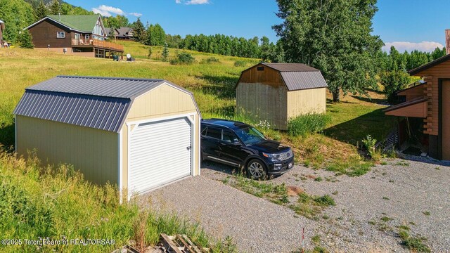 386 Dogwood Dr, Star Valley Ranch, WY 83127 - detached garage with gravel driveway and a shed