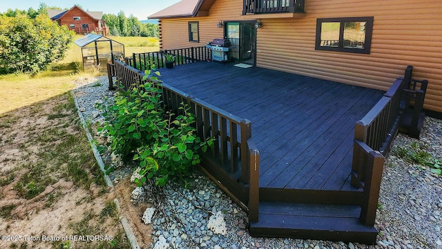 386 Dogwood Dr, Star Valley Ranch, WY 83127 - deck featuring grilling area, an exterior structure, and an outbuilding