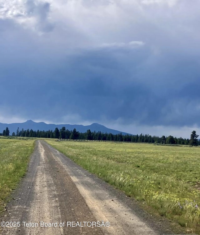 3320 Griffel Ct, Island Park, ID 83429 - view of dirt / gravel road featuring a view of countryside and a mountain view