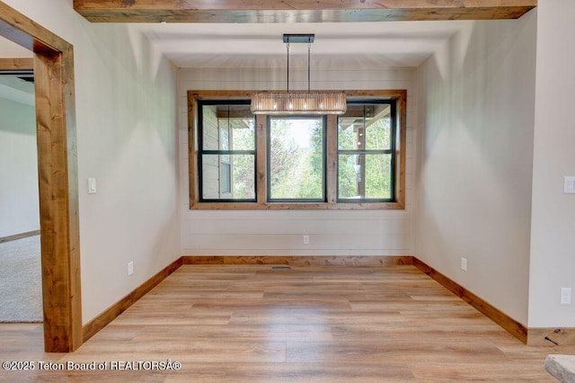 245 Pond Dr, Victor, ID 83455 - unfurnished dining area featuring light wood-type flooring and baseboards