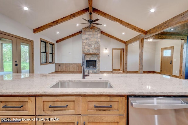 245 Pond Dr, Victor, ID 83455 - kitchen with stainless steel dishwasher, open floor plan, light stone countertops, a fireplace, and recessed lighting