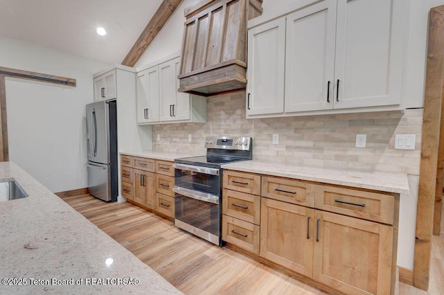 245 Pond Dr, Victor, ID 83455 - kitchen featuring stainless steel appliances, custom exhaust hood, light stone counters, a barn door, and decorative backsplash