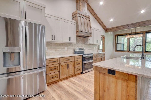 245 Pond Dr, Victor, ID 83455 - kitchen featuring appliances with stainless steel finishes, tasteful backsplash, light stone countertops, light wood finished floors, and recessed lighting